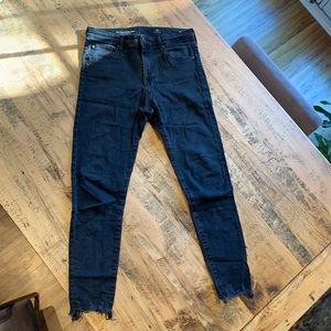 Black Farah Skinny Ankle AG jeans with frayed hem.